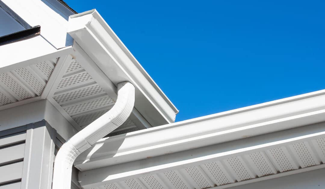 Newly installed white gutters on two-story home