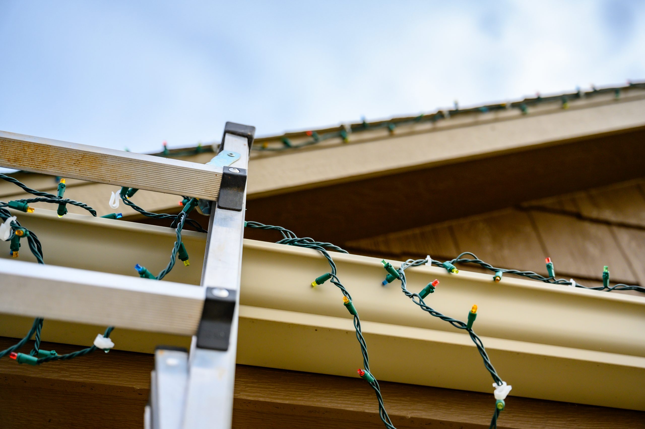 Ladder Leaning on Gutters with Xmas Lights