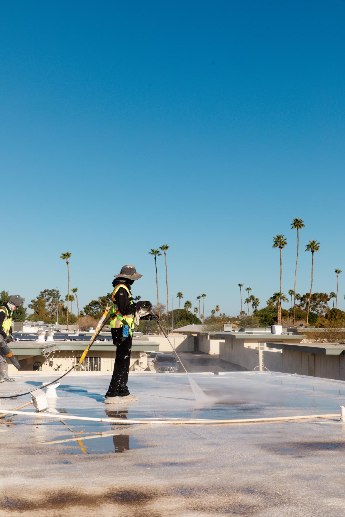 Roofer Power-Washing Roof