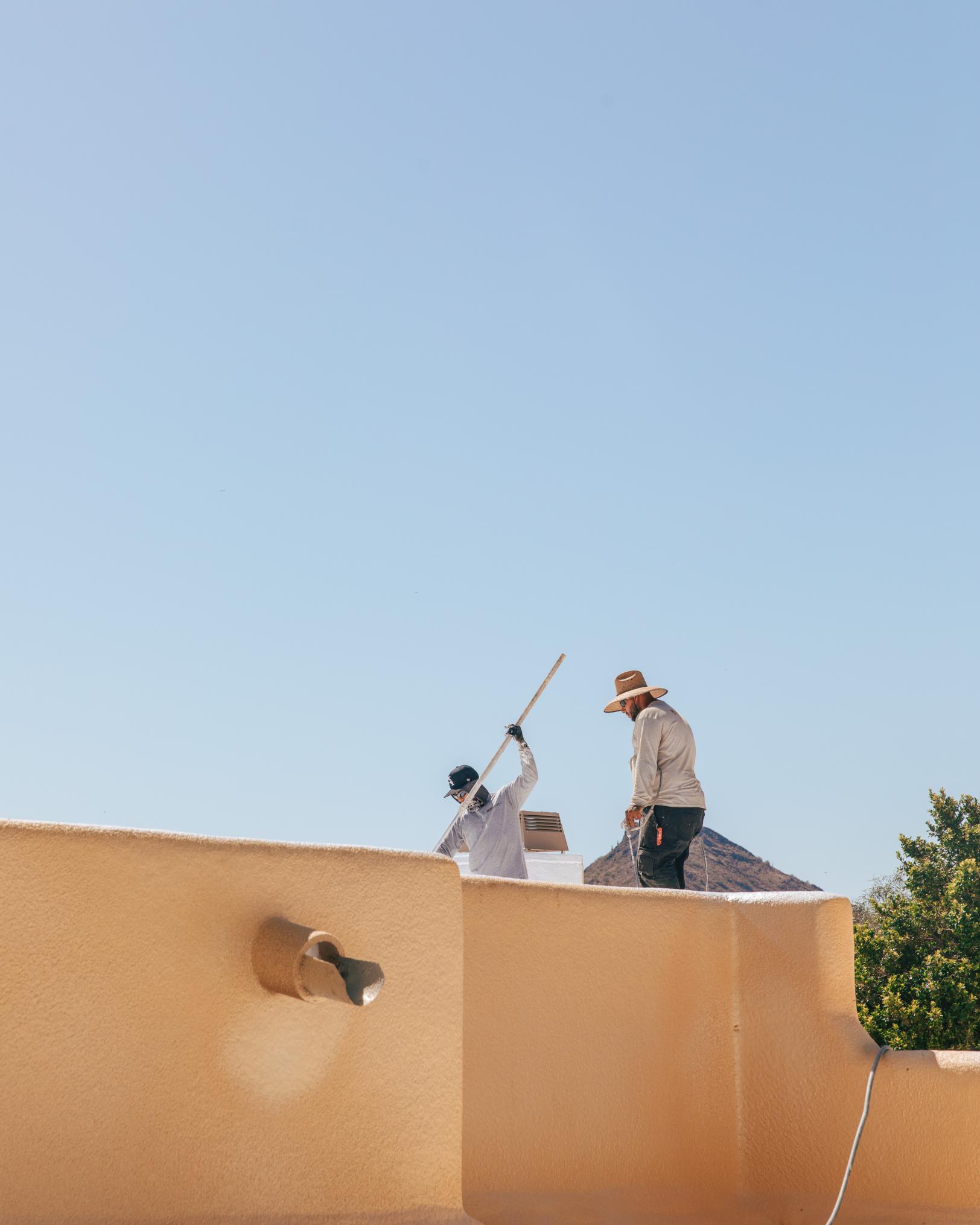 Workers Applying White Roof Coat