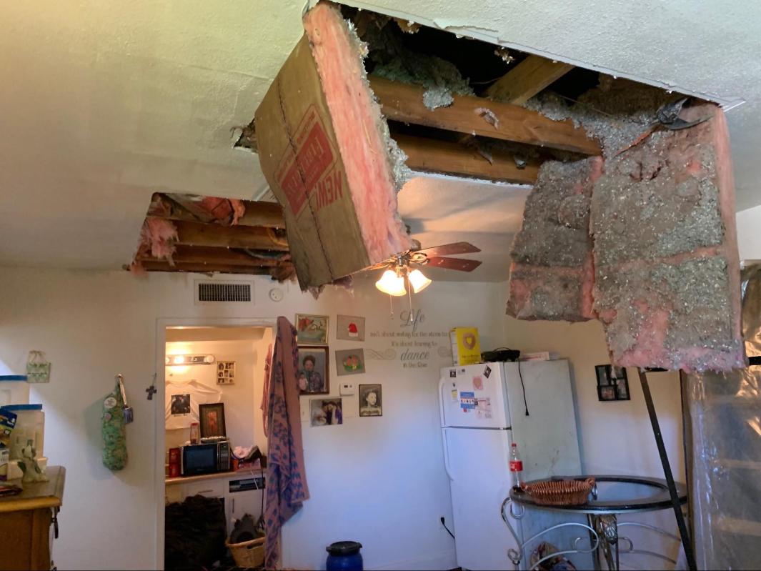 Water-damaged roof collapsed into a living room