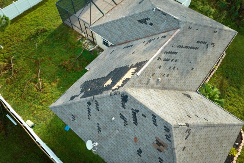 birds eye view of damaged shingle roof from monsoon season