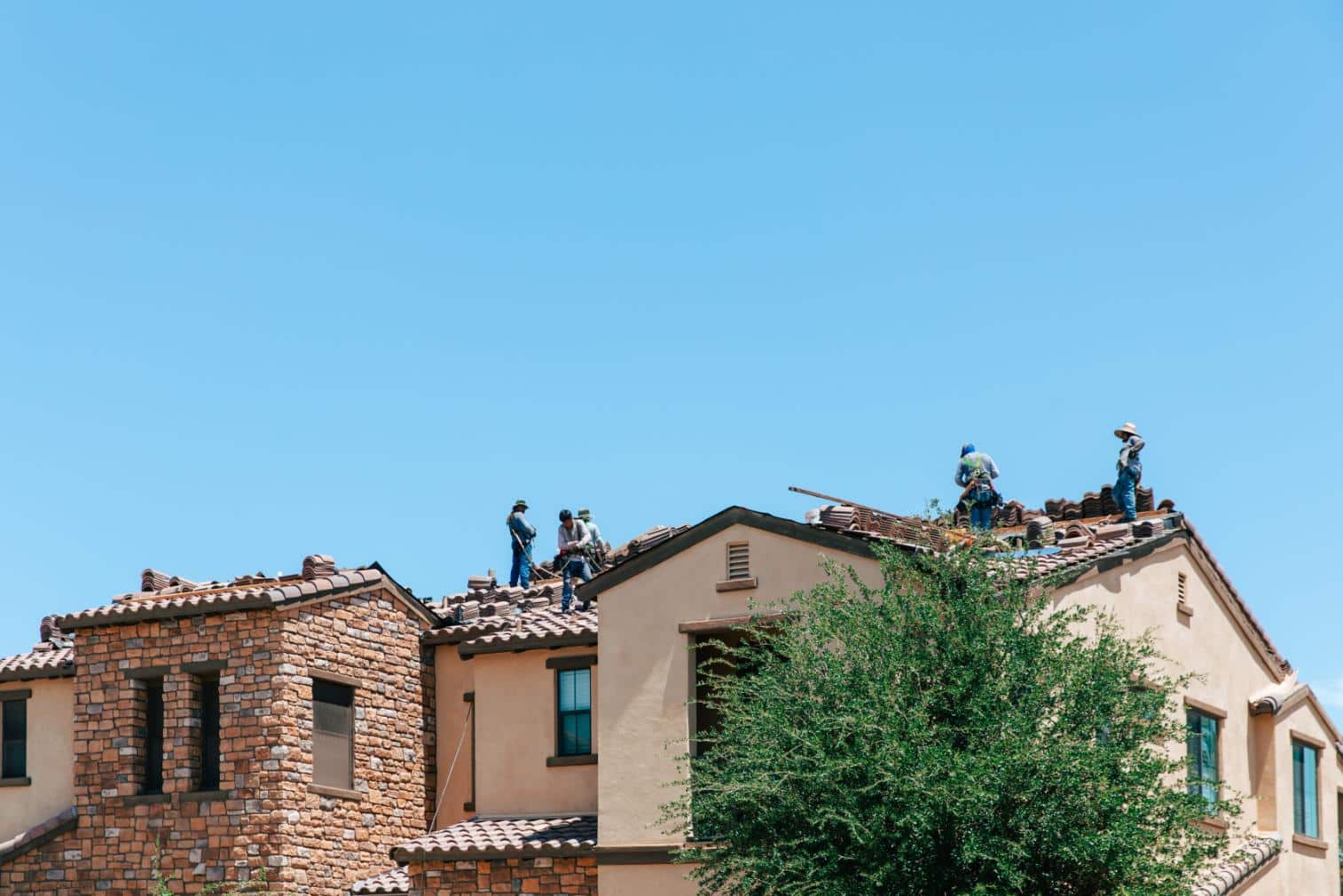 Workers Applying White Roof Coat