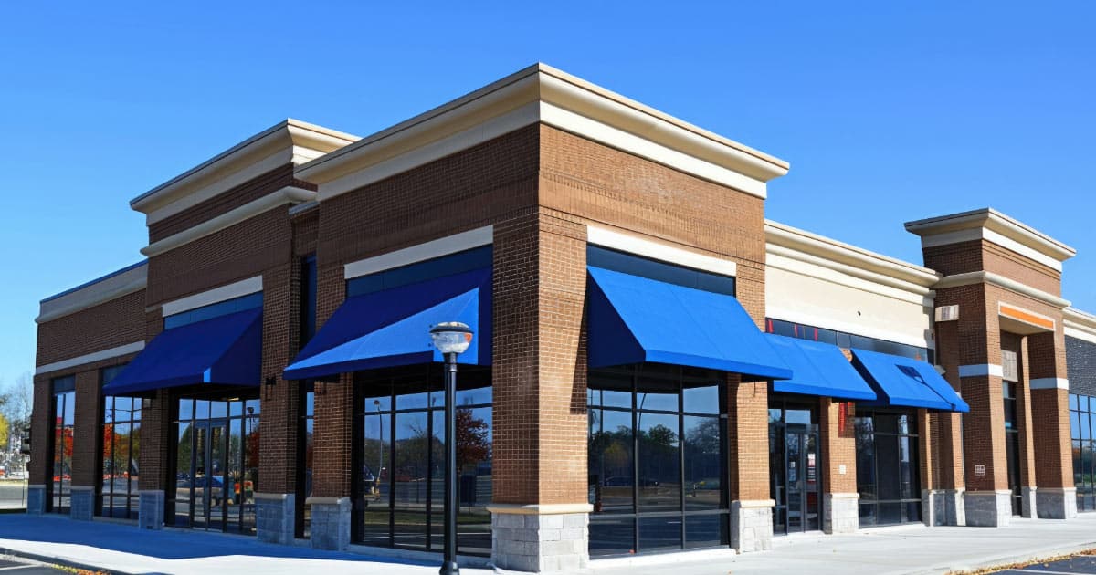 Retail store strip mall with blue awnings