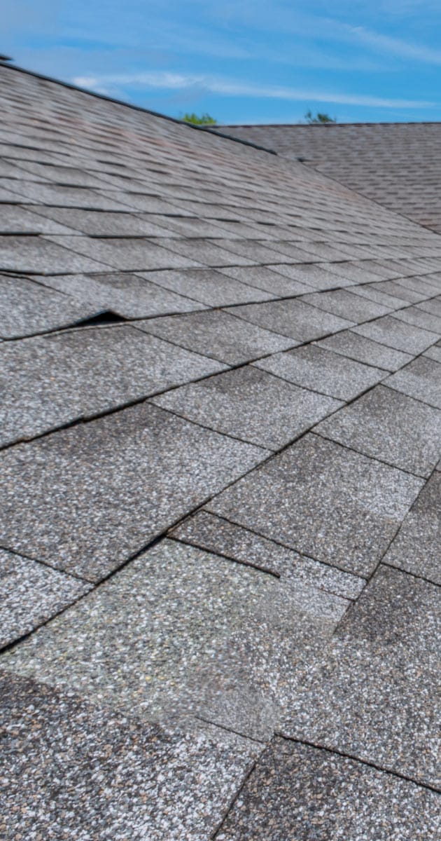 Roof with buckled tiles that needs maintenance