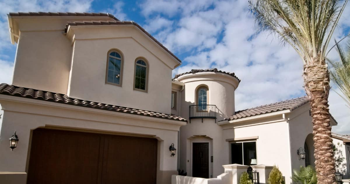 Two-story Spanish-style house with concrete tile roofing