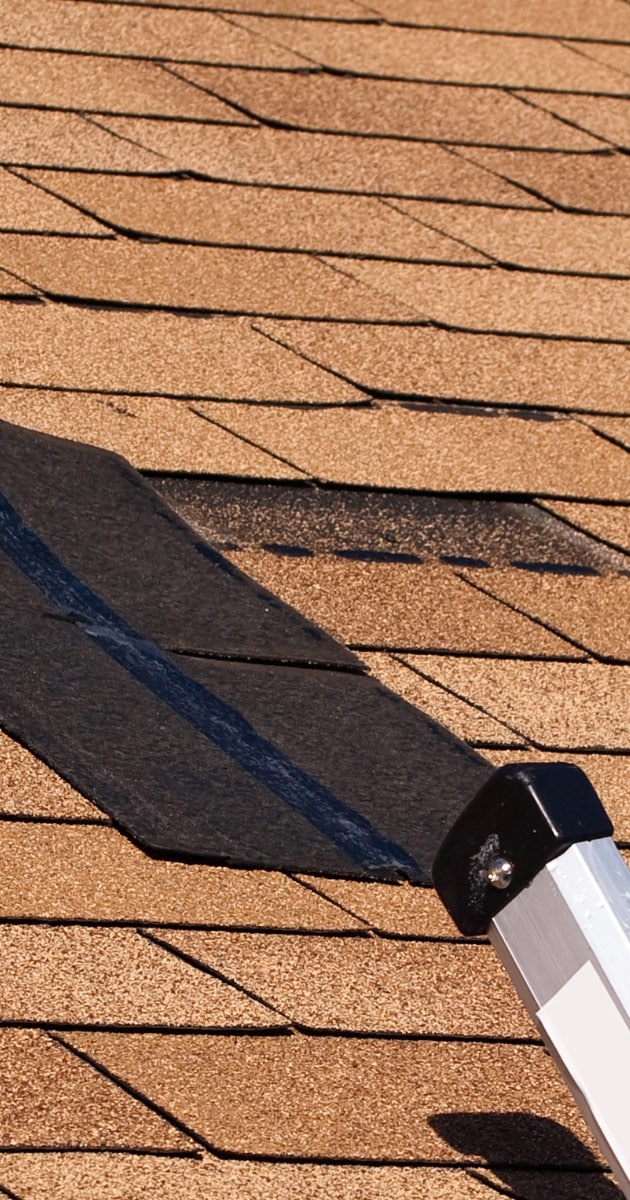 Roof tiles blown loose after a monsoon storm